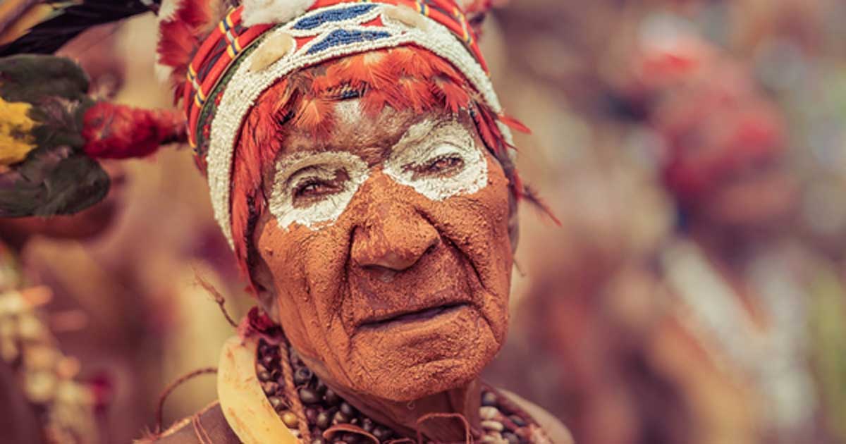 A New Guinean woman in traditional wear and face paint